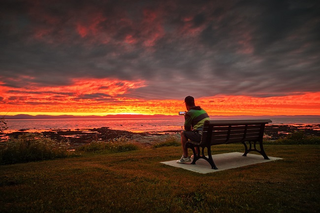 Rivière-du-Loup, homme qui prend en photo le coucher de soleil  