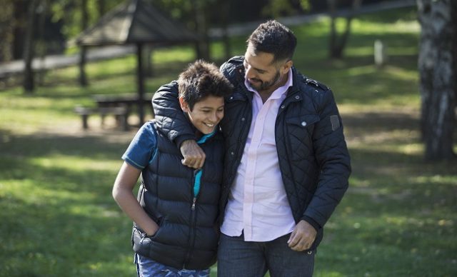 Father and son in public park